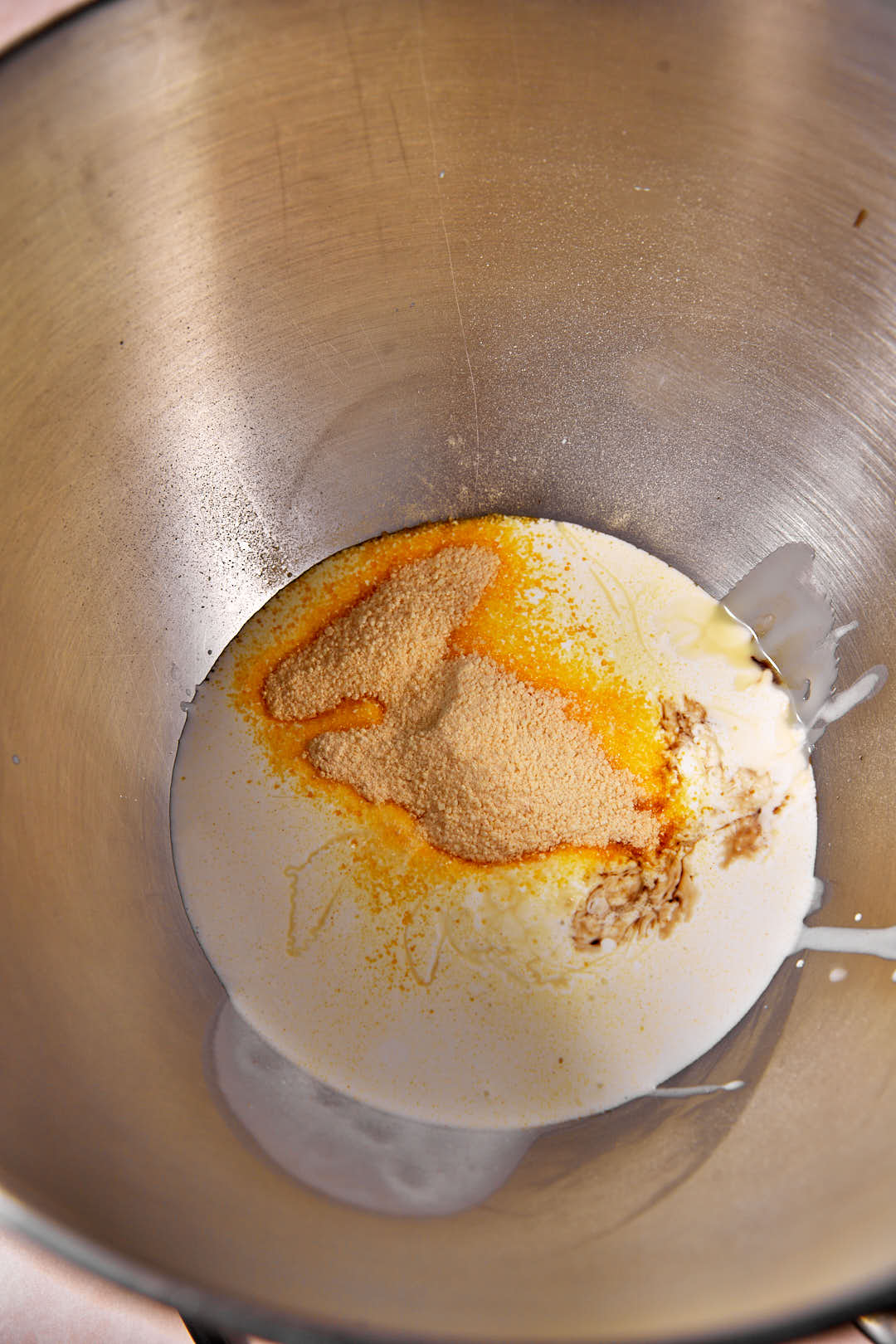 creme caramel powder, condensed milk and heavy cream in a steel mixing bowl