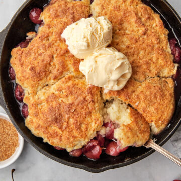 cherry cobblrer with a spoon taking a big scoop out.
