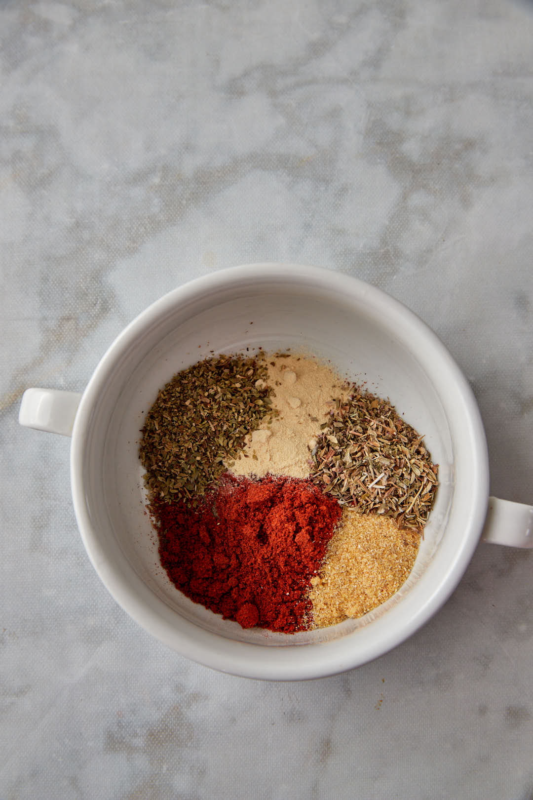 the spices for the chicken seasoning in a white bowl before mixing.