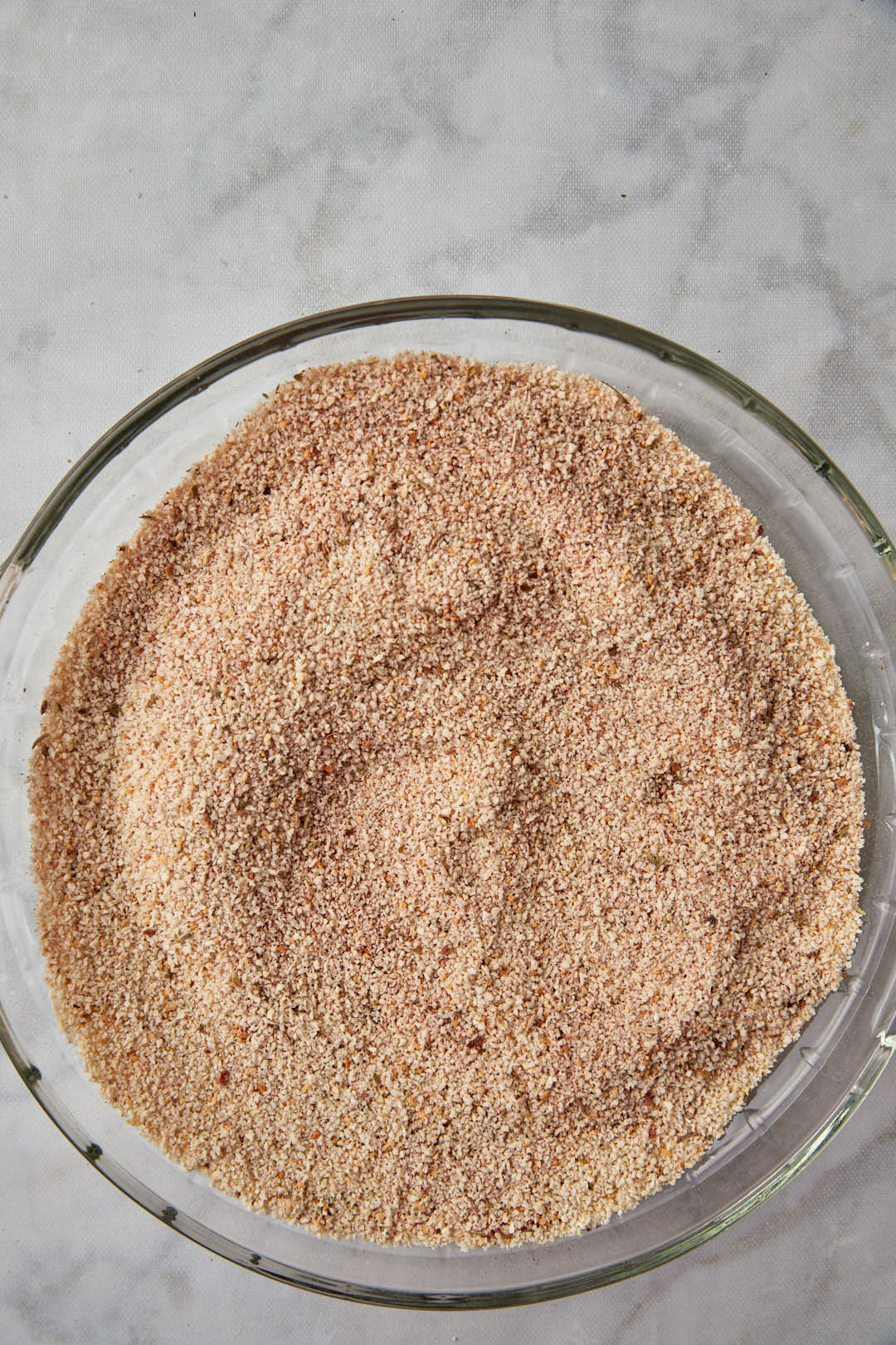 spiced seasoned breadcrumbs stirred together in a pie plate.