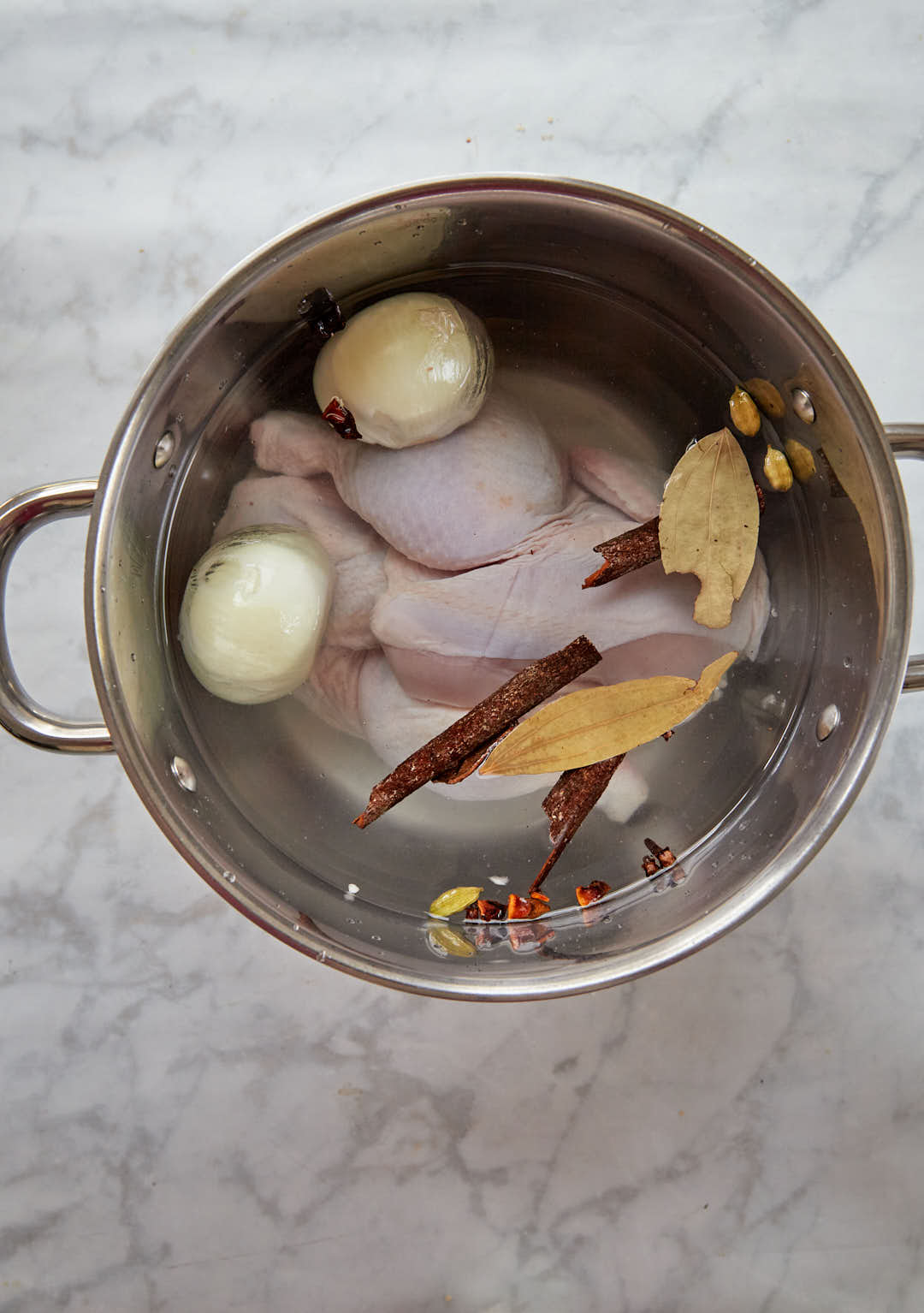 ingredients for chicken broth in a pot.