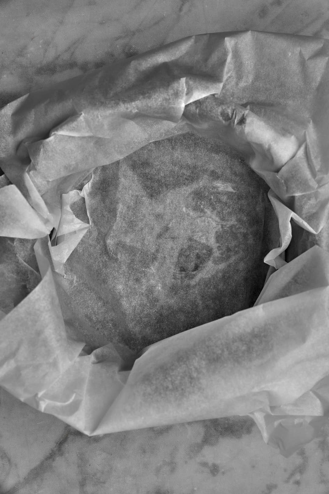 springform pan lined iwth parchment paper extending over the edges