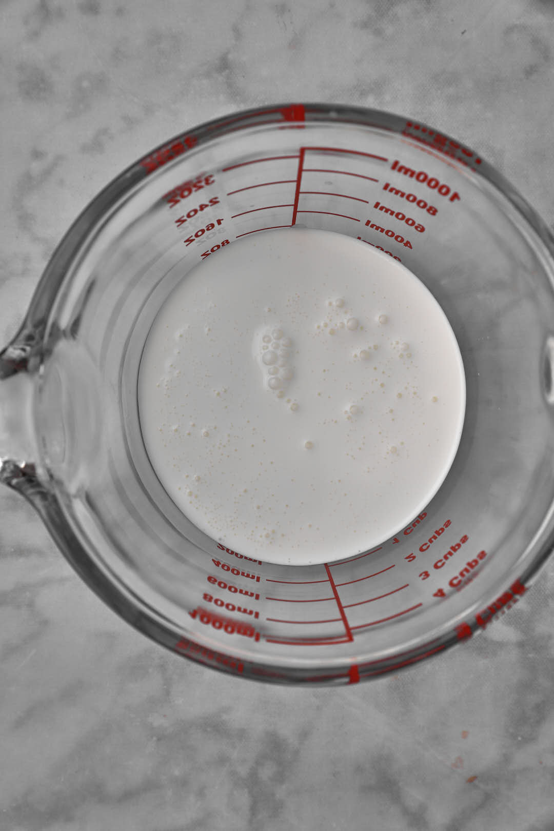 heavy cream in a measuring cup