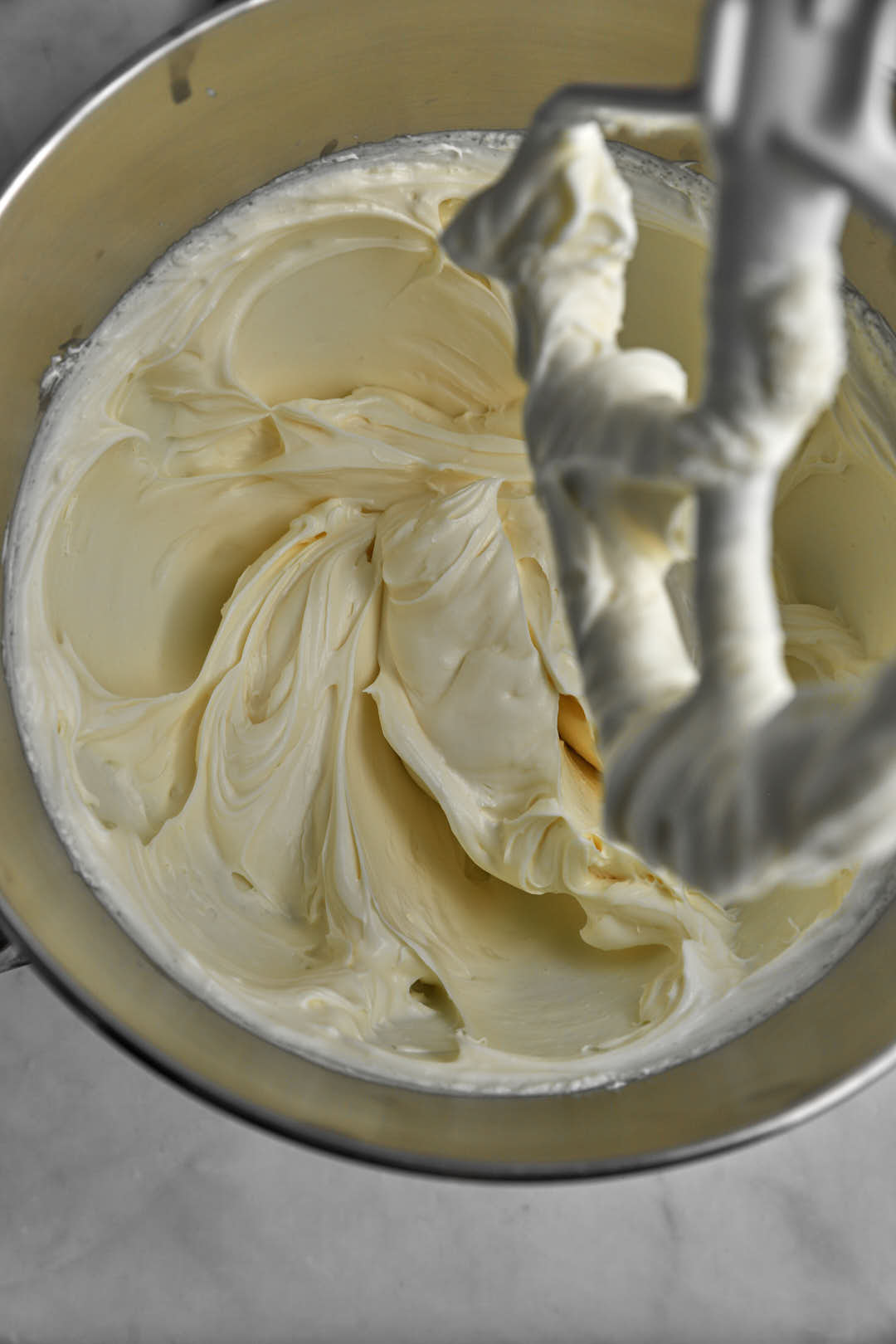 cream cheese and sugar beat together until soft and fluffy in a bowl of a stand mixer.