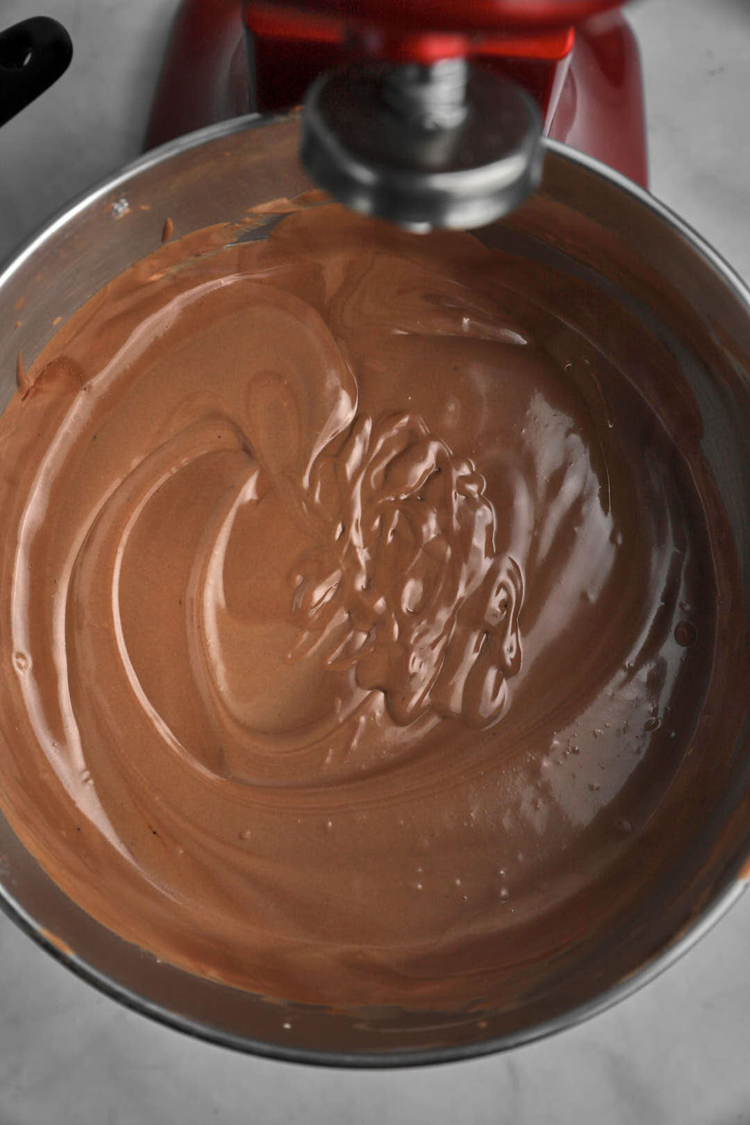Chocolate basque cheesecake batter in bowl of a stand mixer.