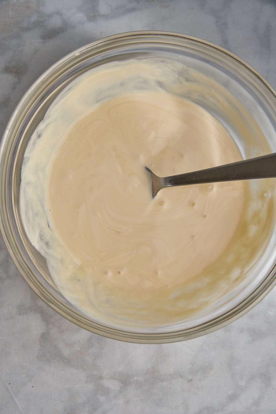 cream and condensed milk mixed in a small bowl.
