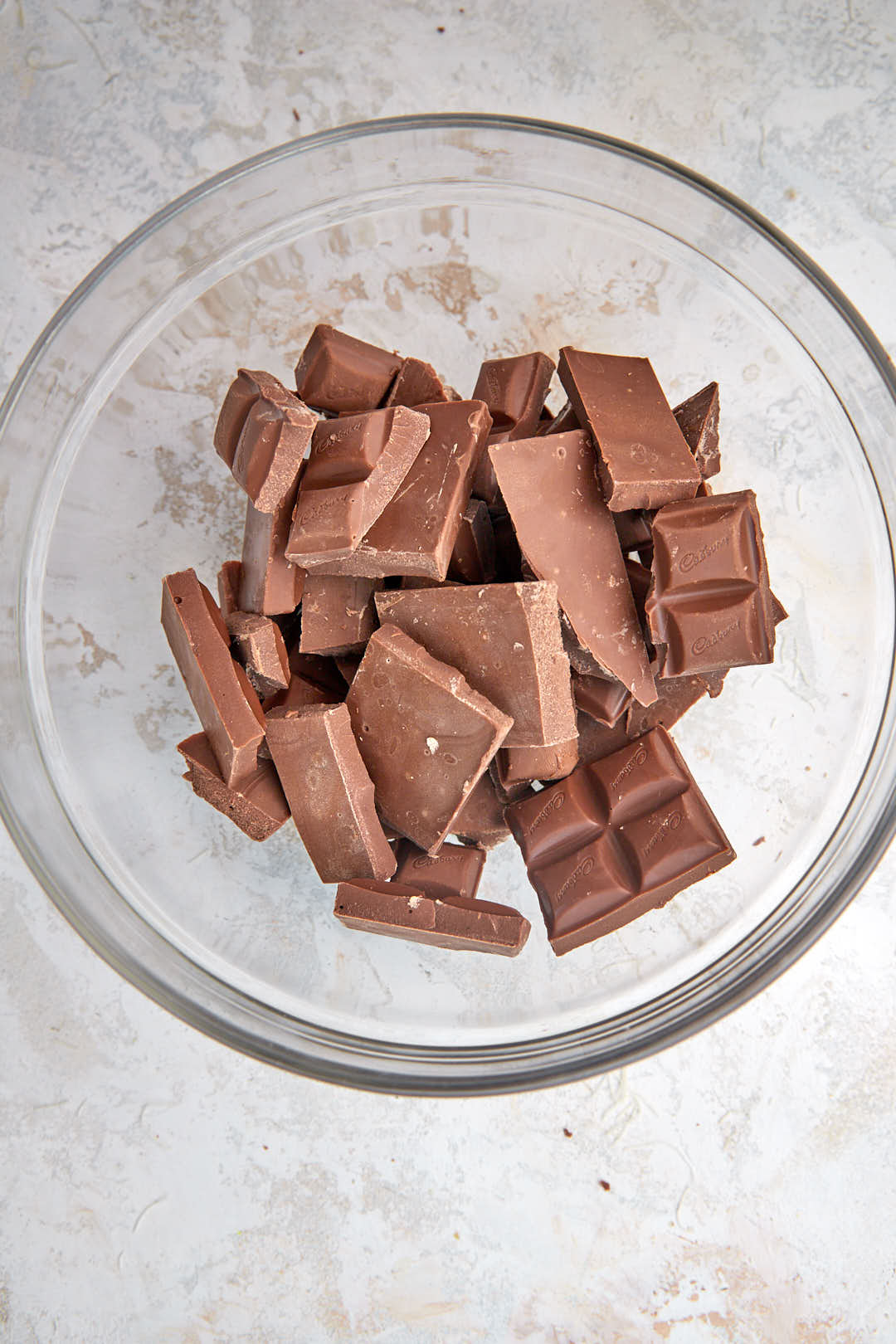 chocolate pieces in a glass bowl before melting.