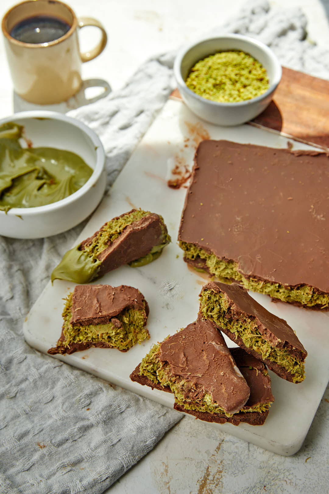 shards of chocolate kunafa bark on marble platter.