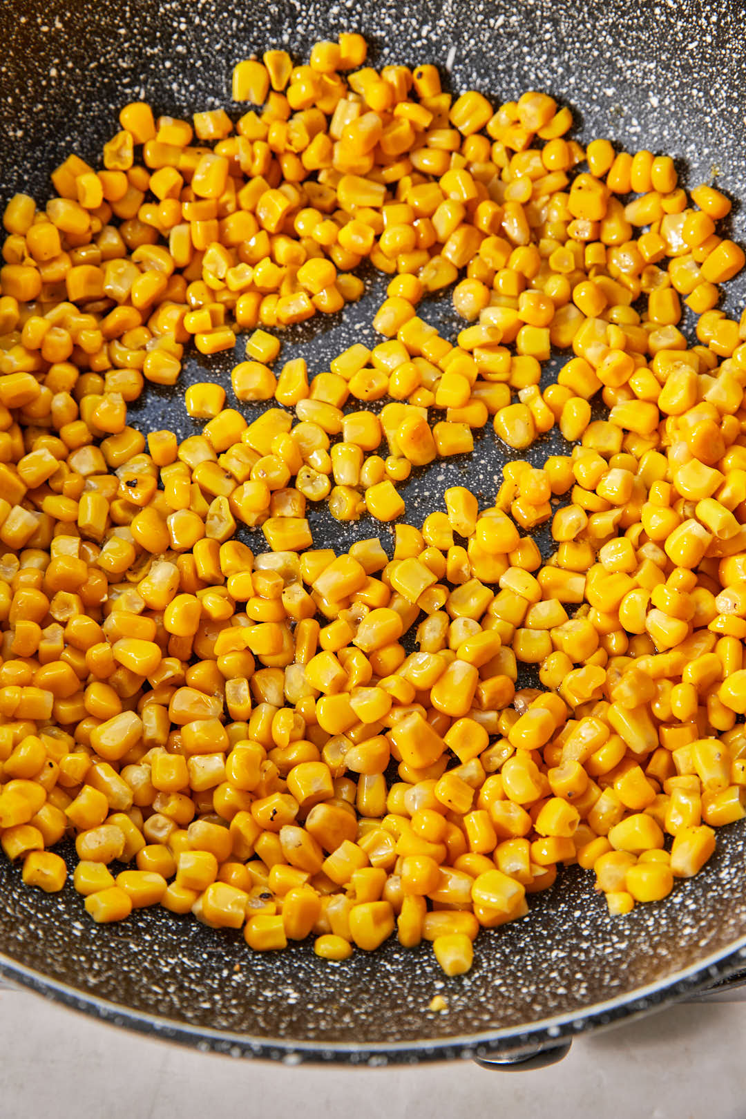 corn added in a single layer to a large hot skillet.