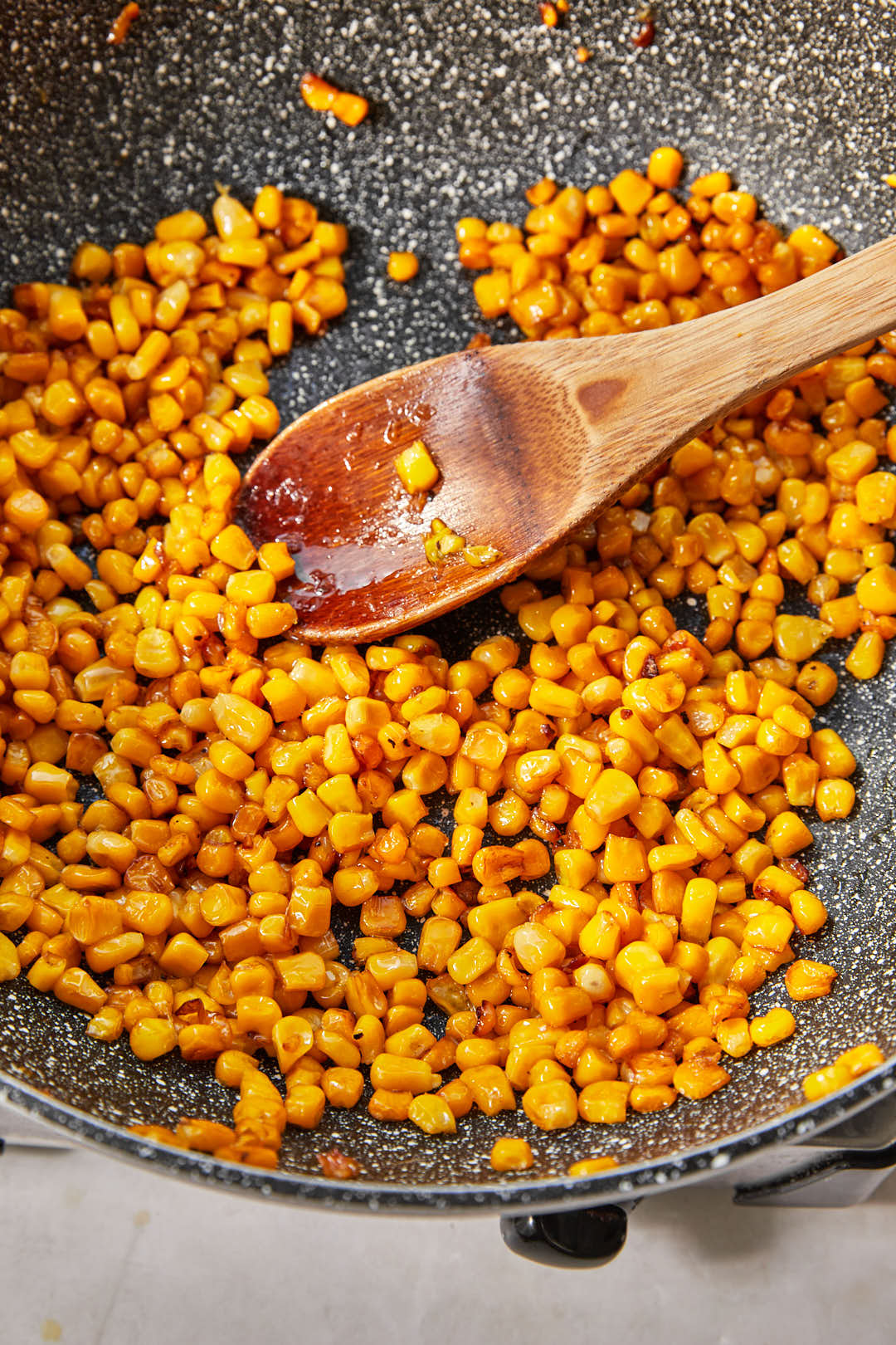 charred corn kernelsin a large dark skillet.