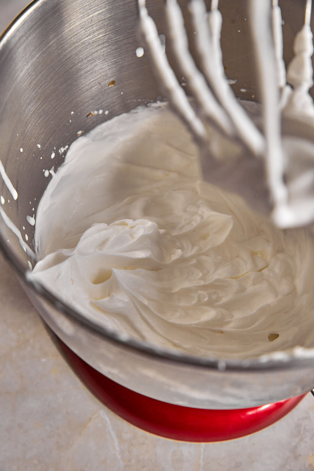 whipped cream in bowl of kitchen aid mixer.