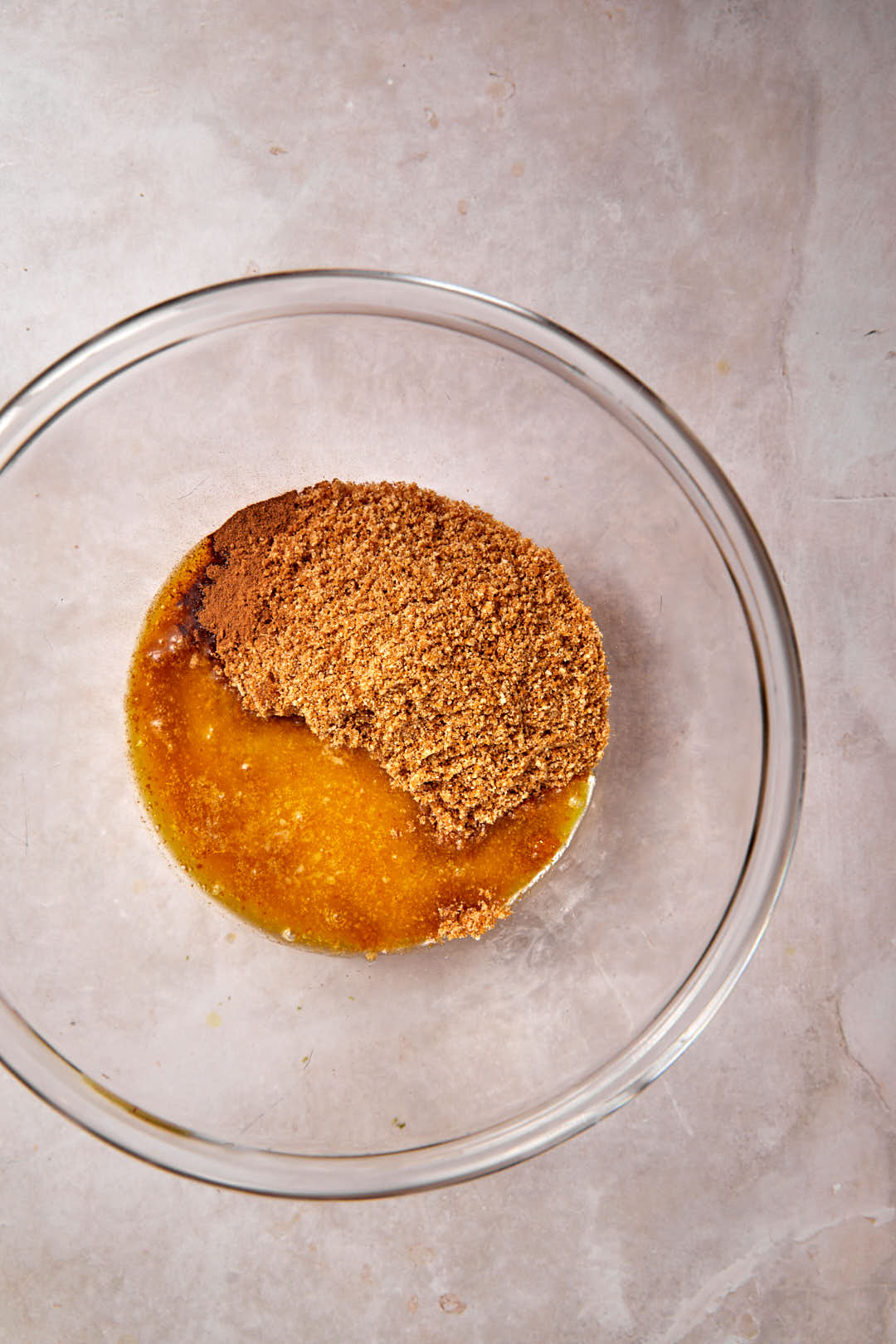 biscoff crust ingredients added to a glass bowl.