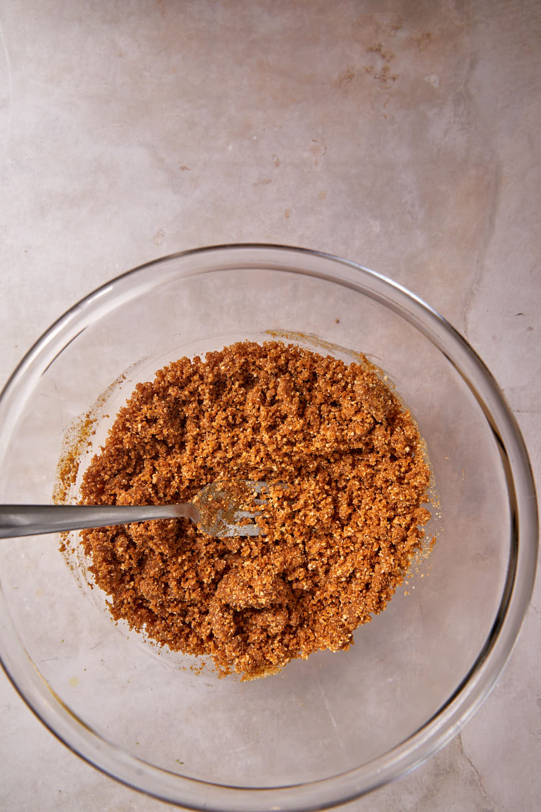 biscoff crust mixed together in a glass bowl.