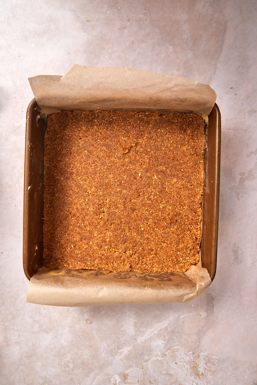 biscoff crust pressed firmly in square baking pan.