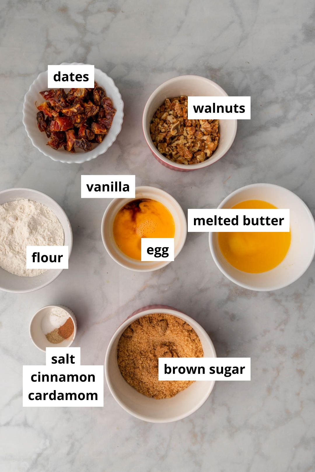 ingredients for date blondies on a marble background.