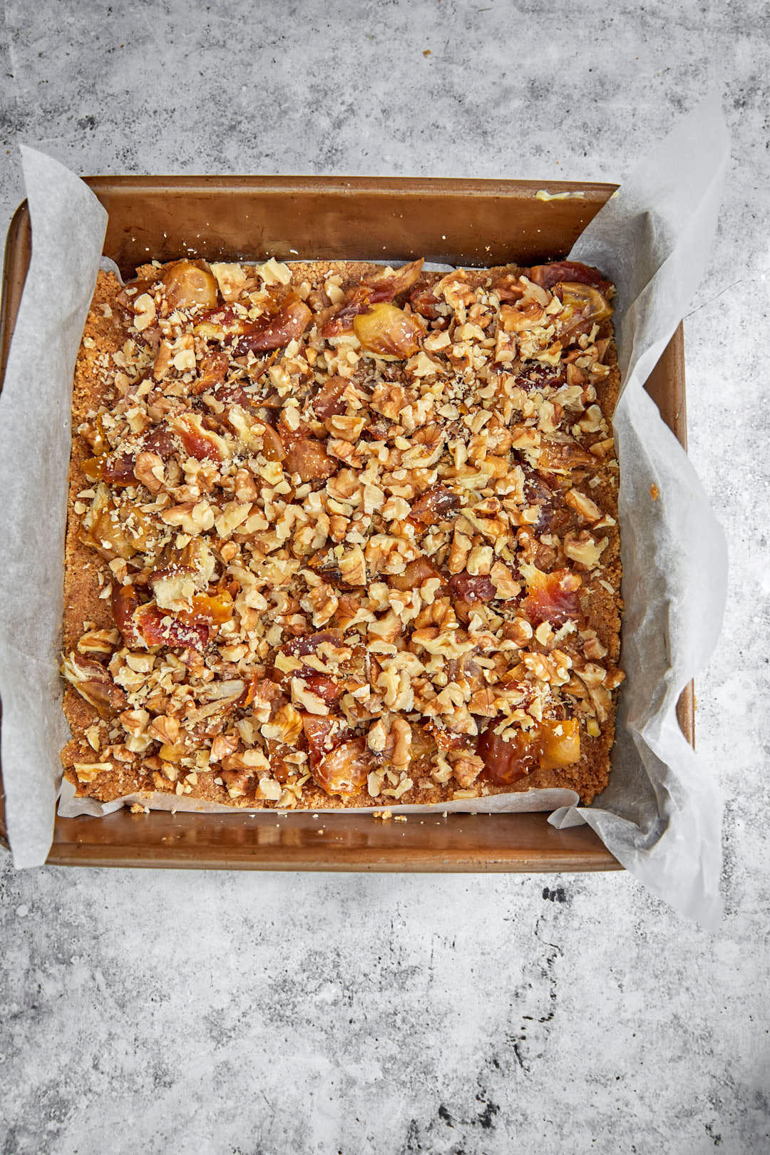 dates and walnuts scatter on biscuit base.