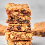Zoomed in photo of 5 date and walnut blondies stacked on top of each other.