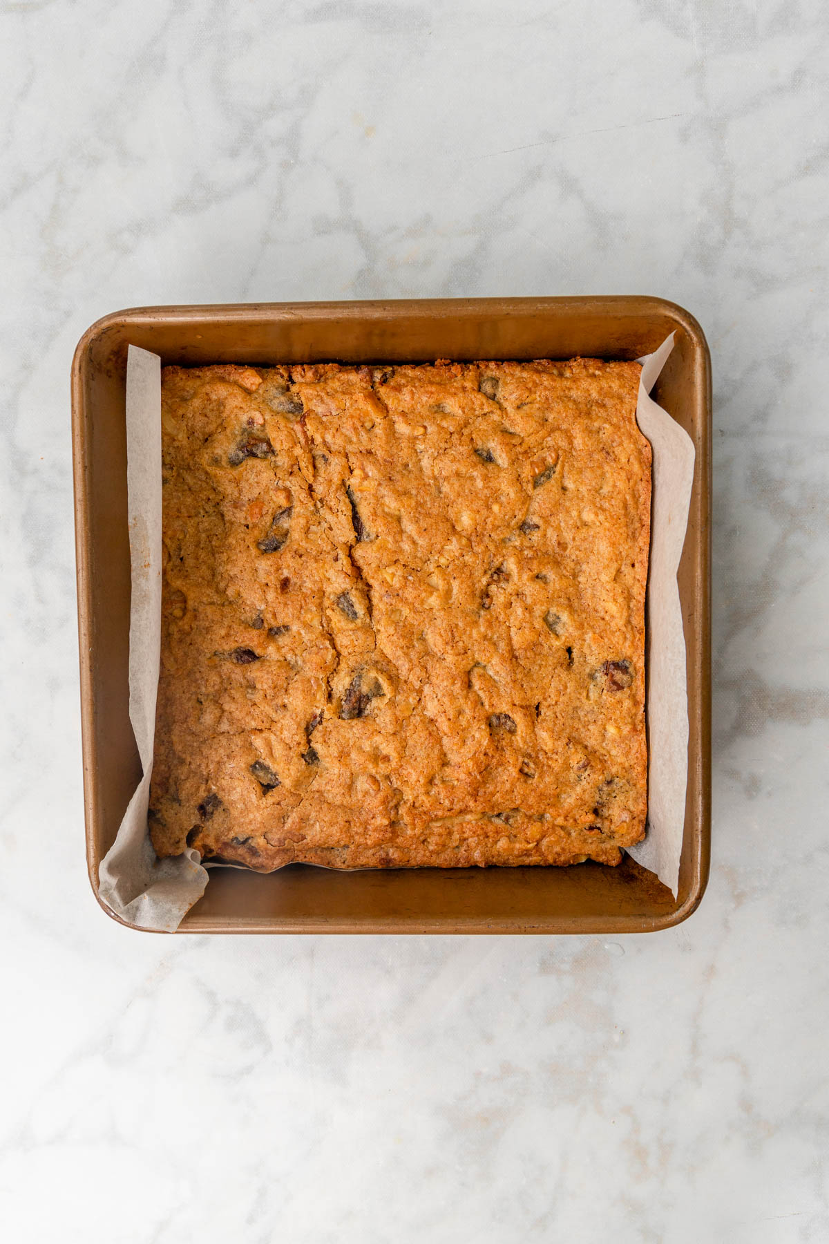 date blondies baked in a square pan.