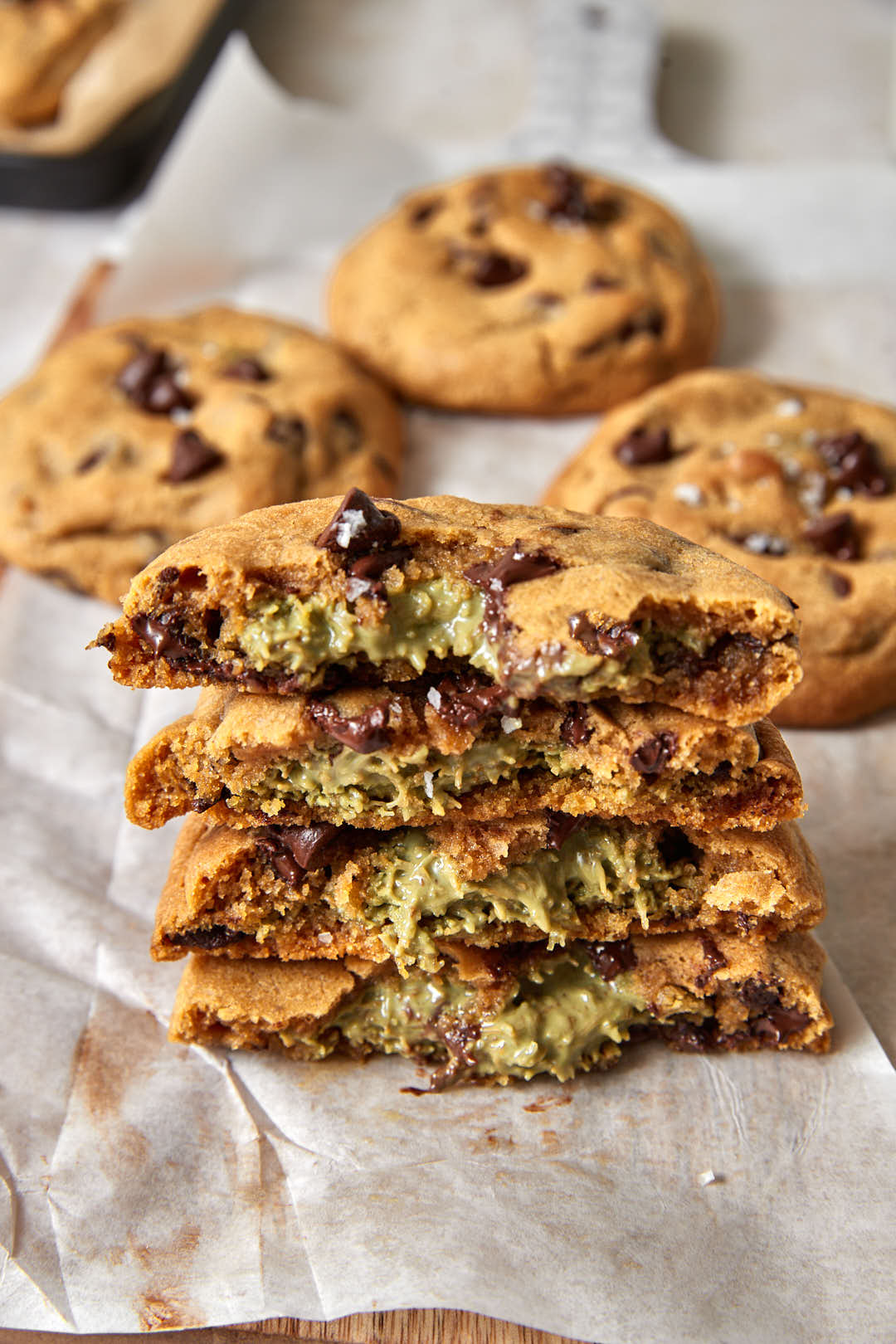 stack of dubai chocolate cookies with pistachio kunafa filling in the middle.
