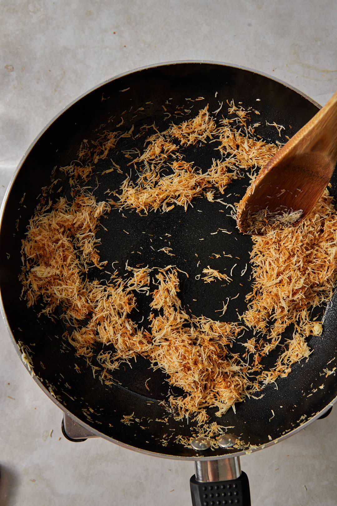 Toast until golden brown, stirring constantly.