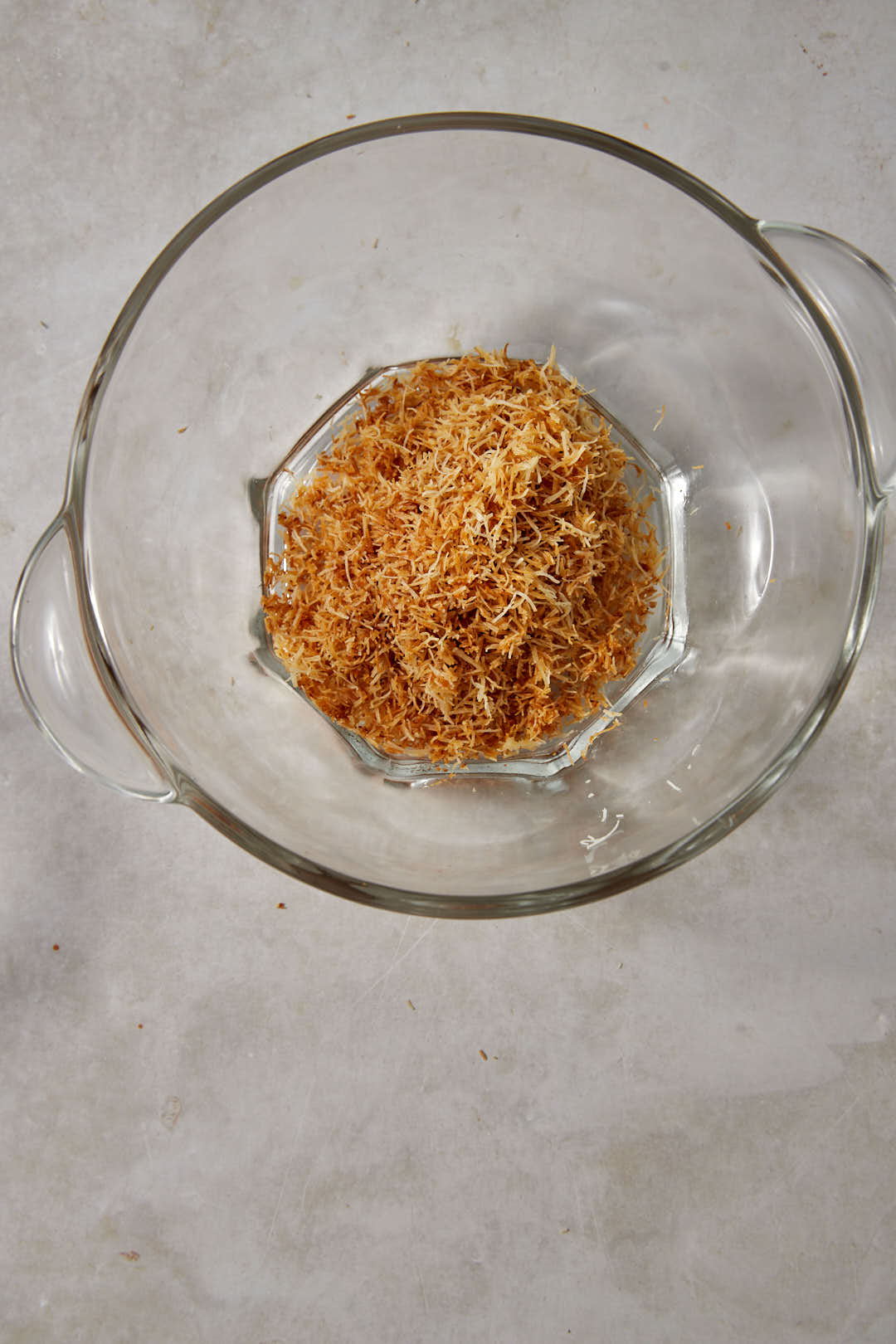Toasted kunafa dough in a medium glass bowl.