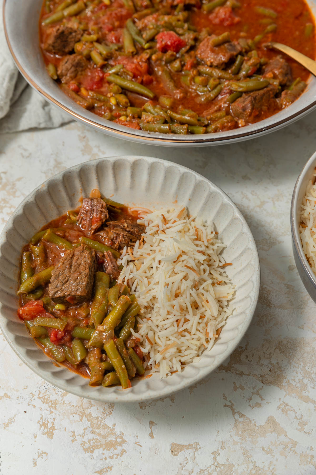 Lebanese green bean stew with vermicelli rice in a bowl.