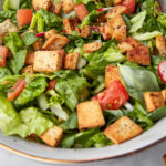 salad dressing being drizzled onto fattouch.