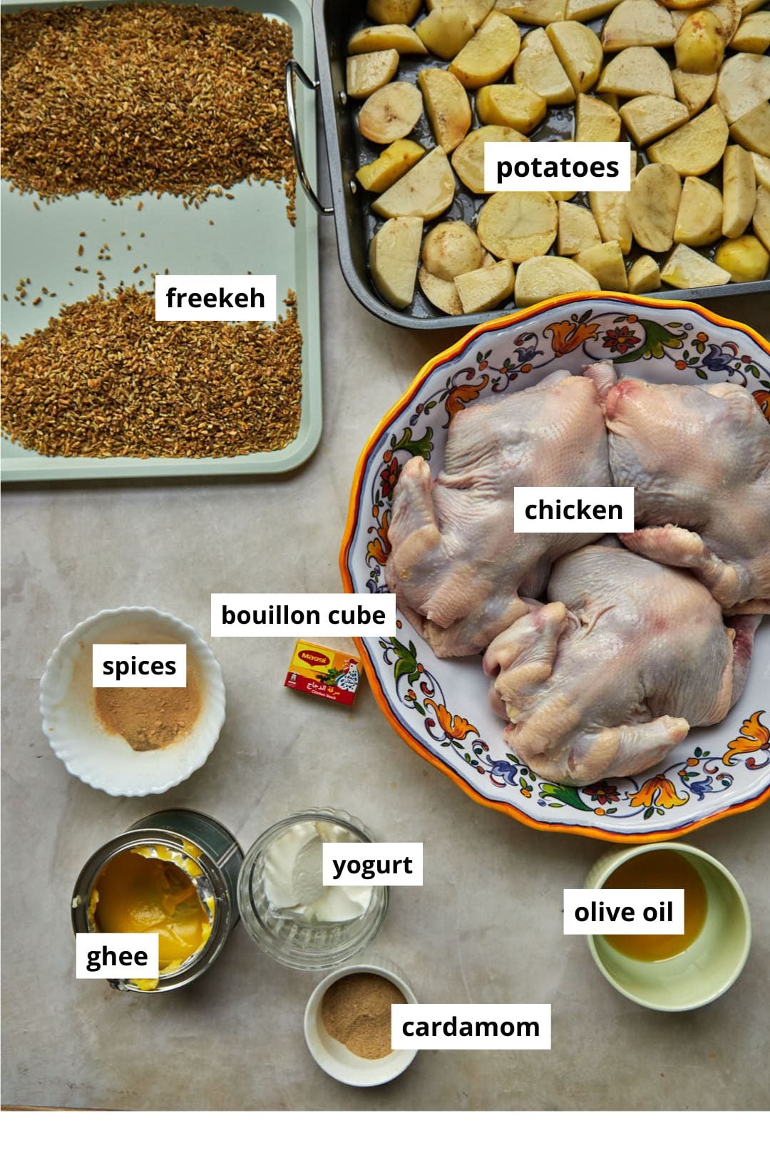 ingredients needed to make freekeh with chicken on a white background.