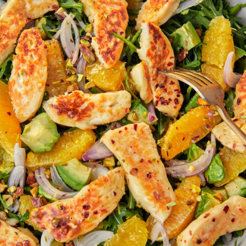 fried halloumi avocado and orange salad in a gray serving bowl.