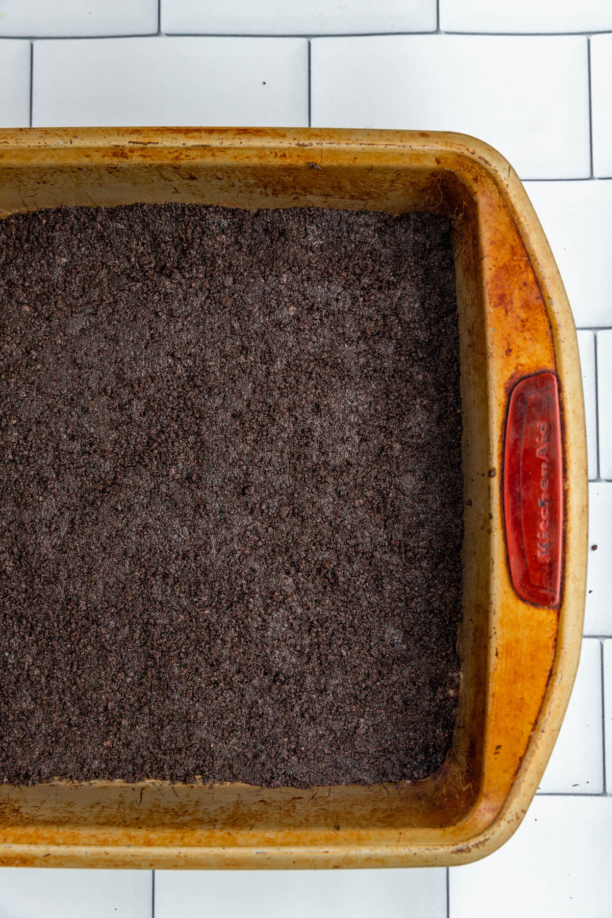 Oreo crust in a square pan.