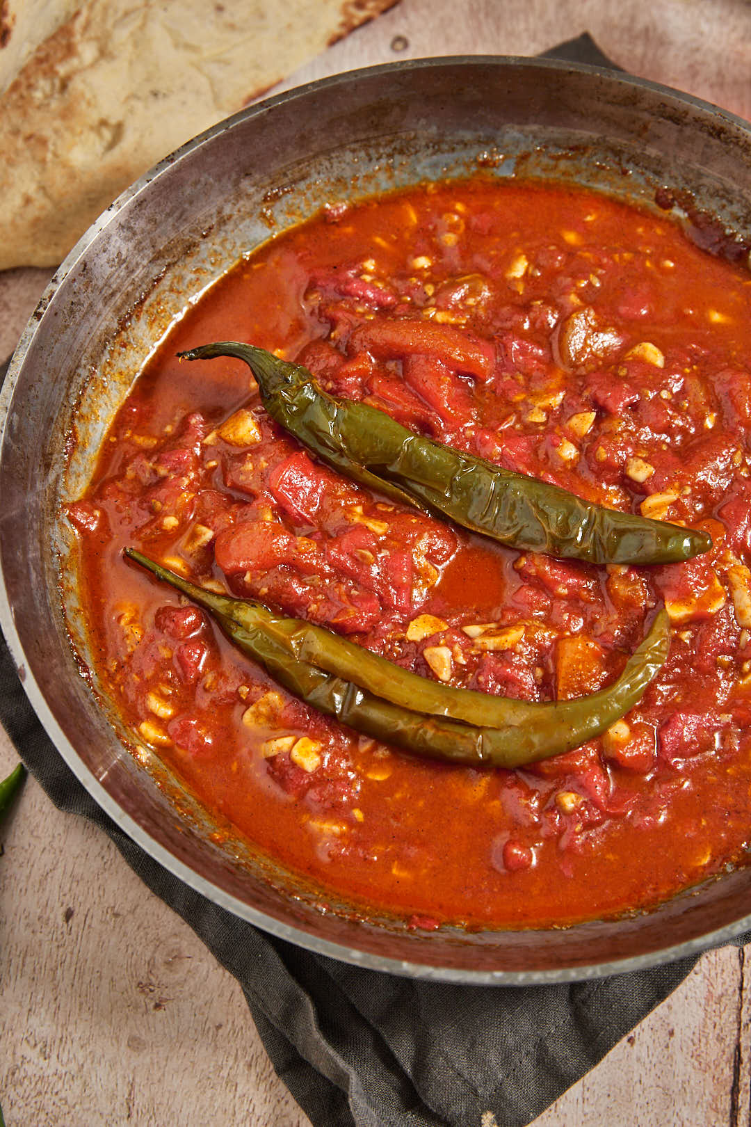 close up photo of galayet bandora with two green chili peppers inside.