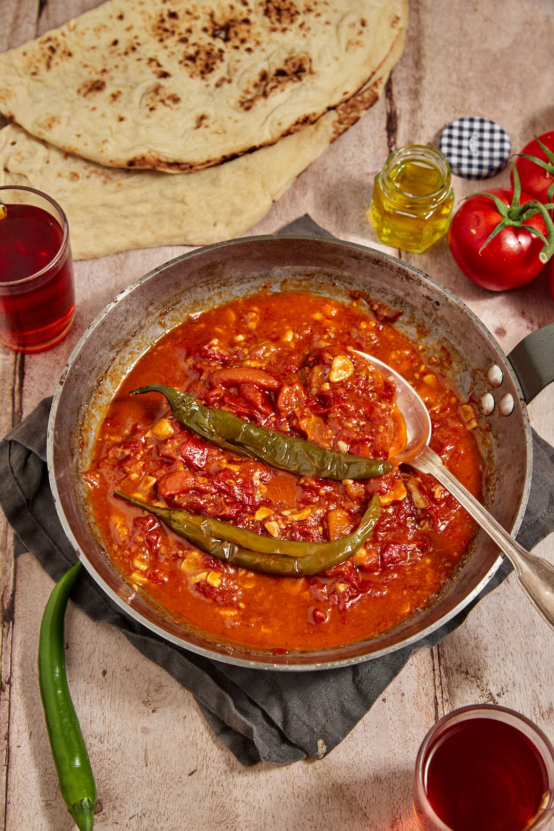 galayet bandora with bread, tea, and extra tomatoes on the background.