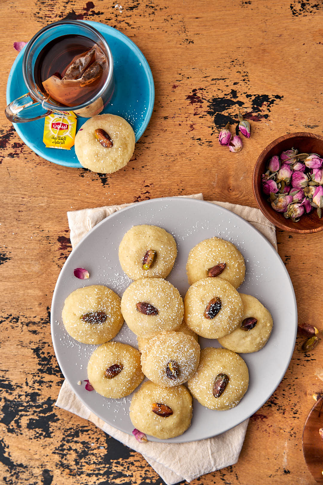 plate of middle eastenr shortbread cookies with a small cup of tea in the background