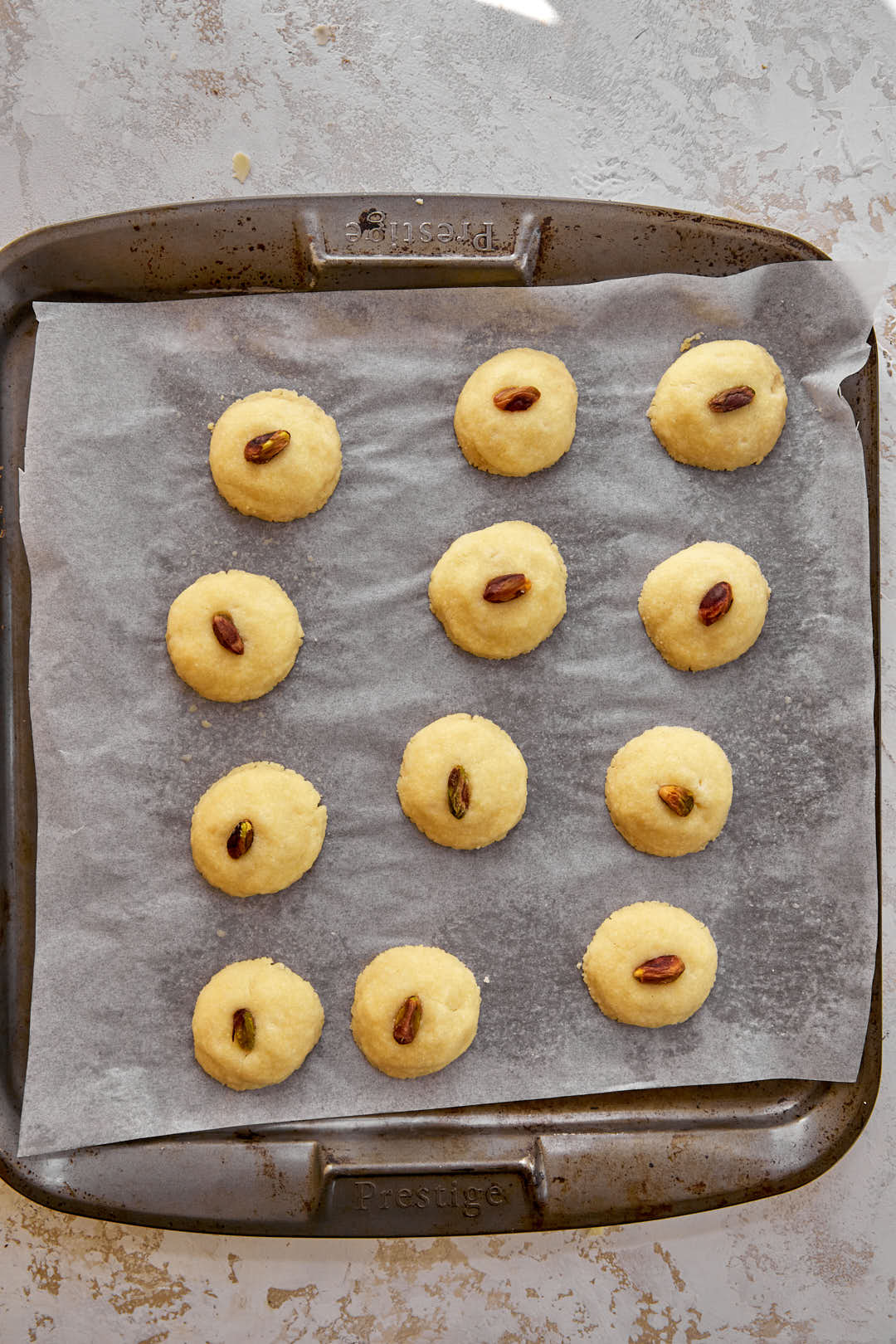 baked ghraybeh balls on baking sheet.