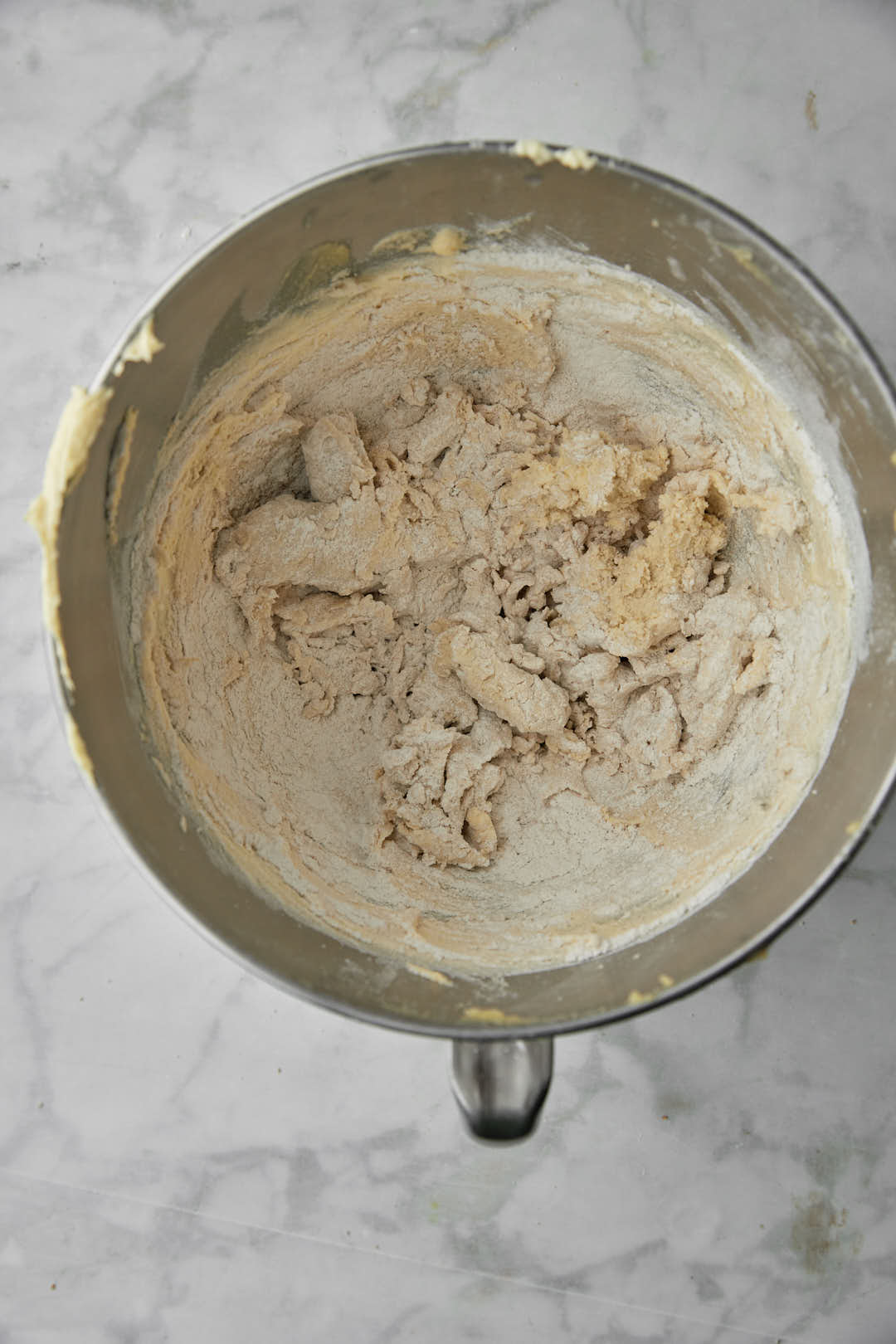 flour added to ghee and sugar in a stand mixer
