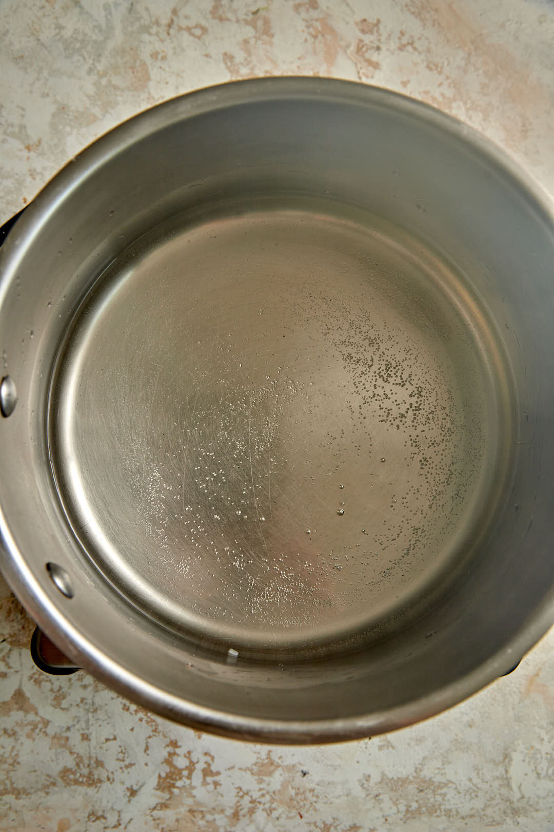 simmering sugar water in a saucepan.