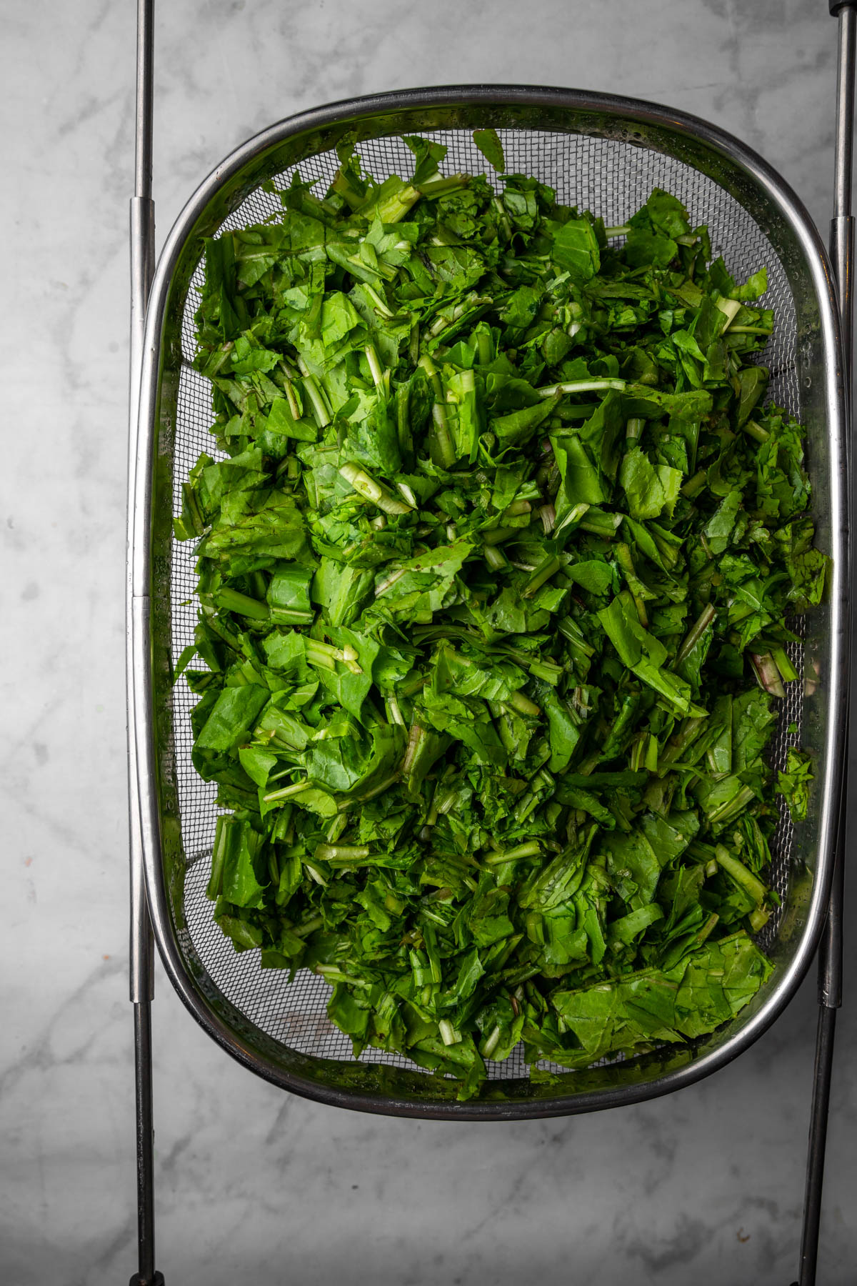 dandelion greens in colander.