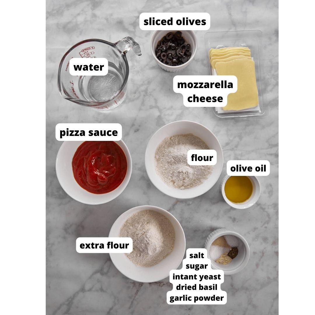 ingredients for making mini pizzas on white background