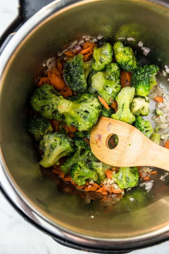 broccoli carrots and garlic being sauteed in instant pot