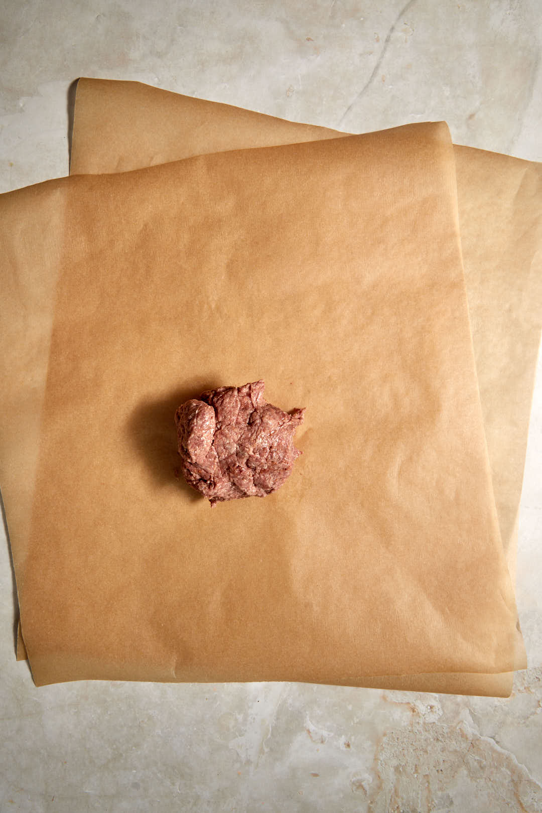 raw doner mix shaped into a ball on parchment paper.