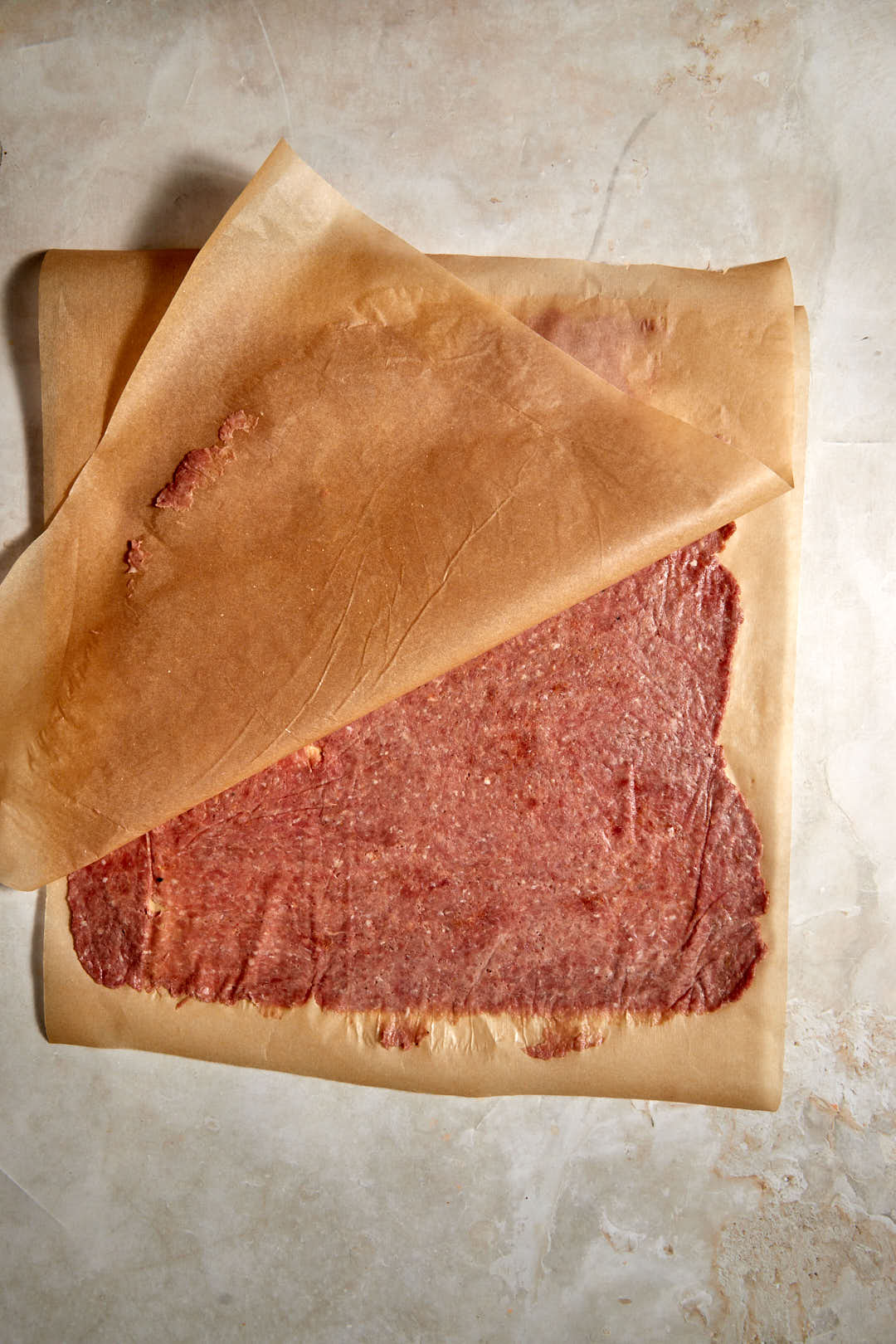 parchment paper being peeled open to reveal kebab meat.