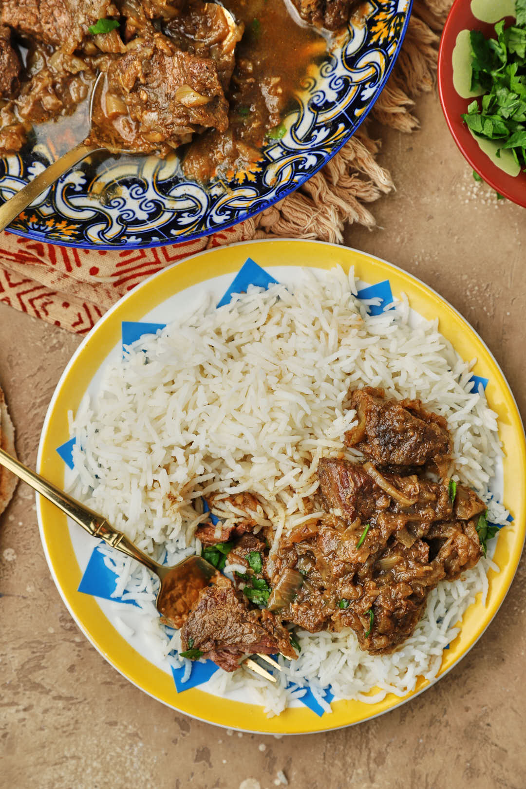 kabab halla with rice on a colorful plate.