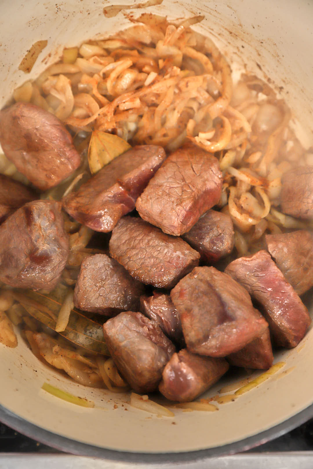 beef cubes added to sauteed onions.