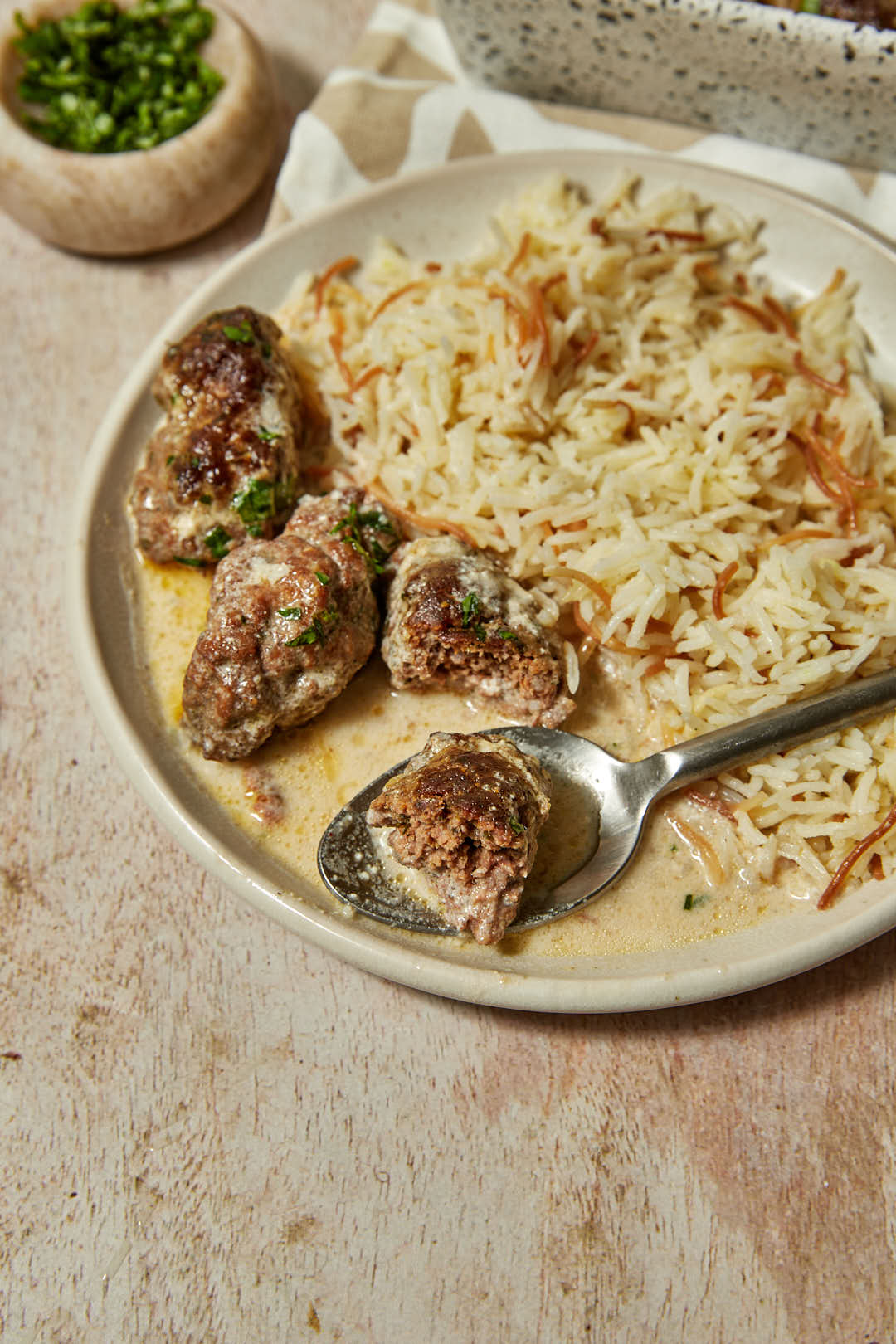 tahini kofta with a spoon on a plate.