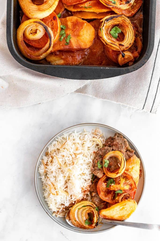 baked kafta in a pan with a side of rice