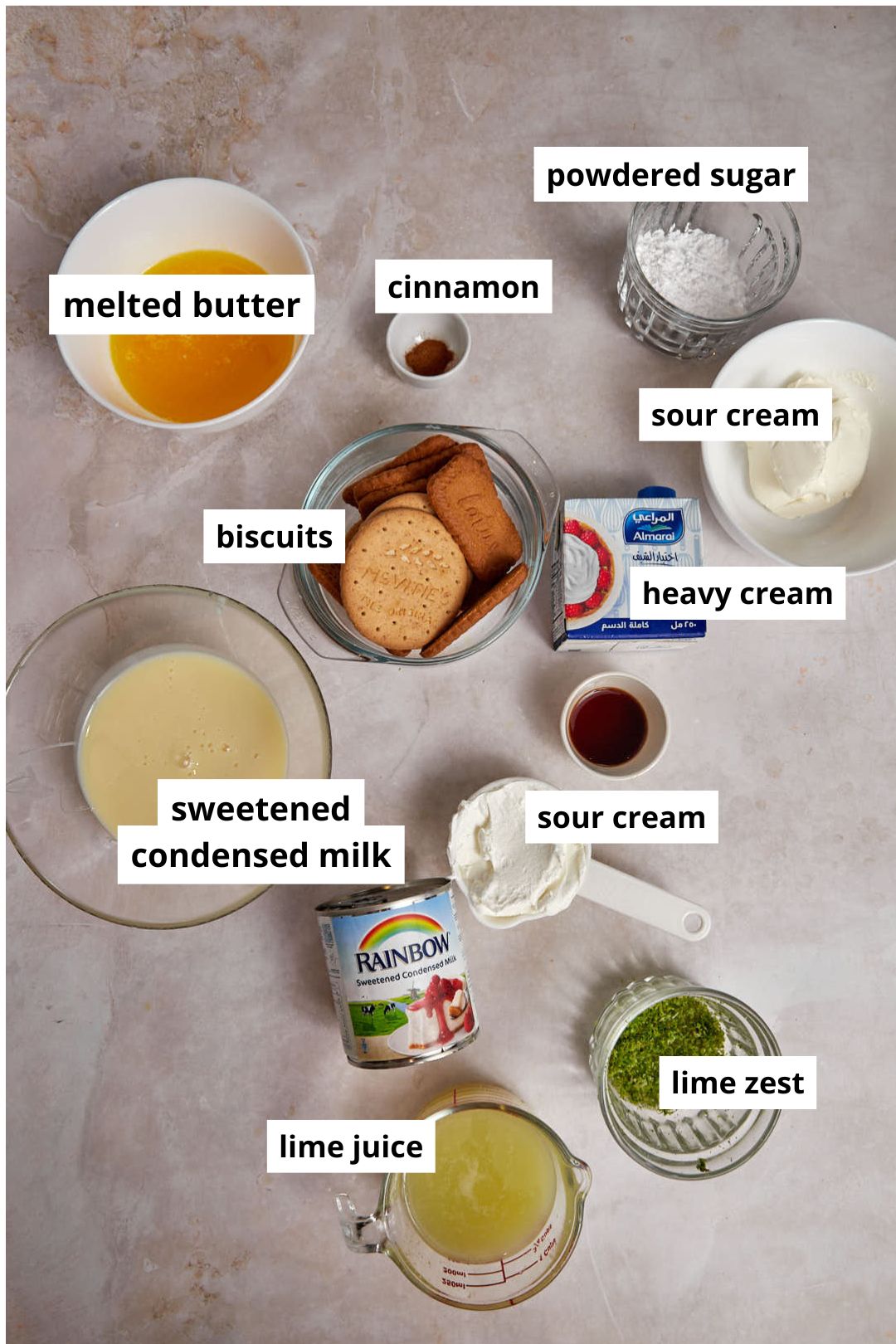 ingredients needed to make key lime pie bars on a warm marble background.