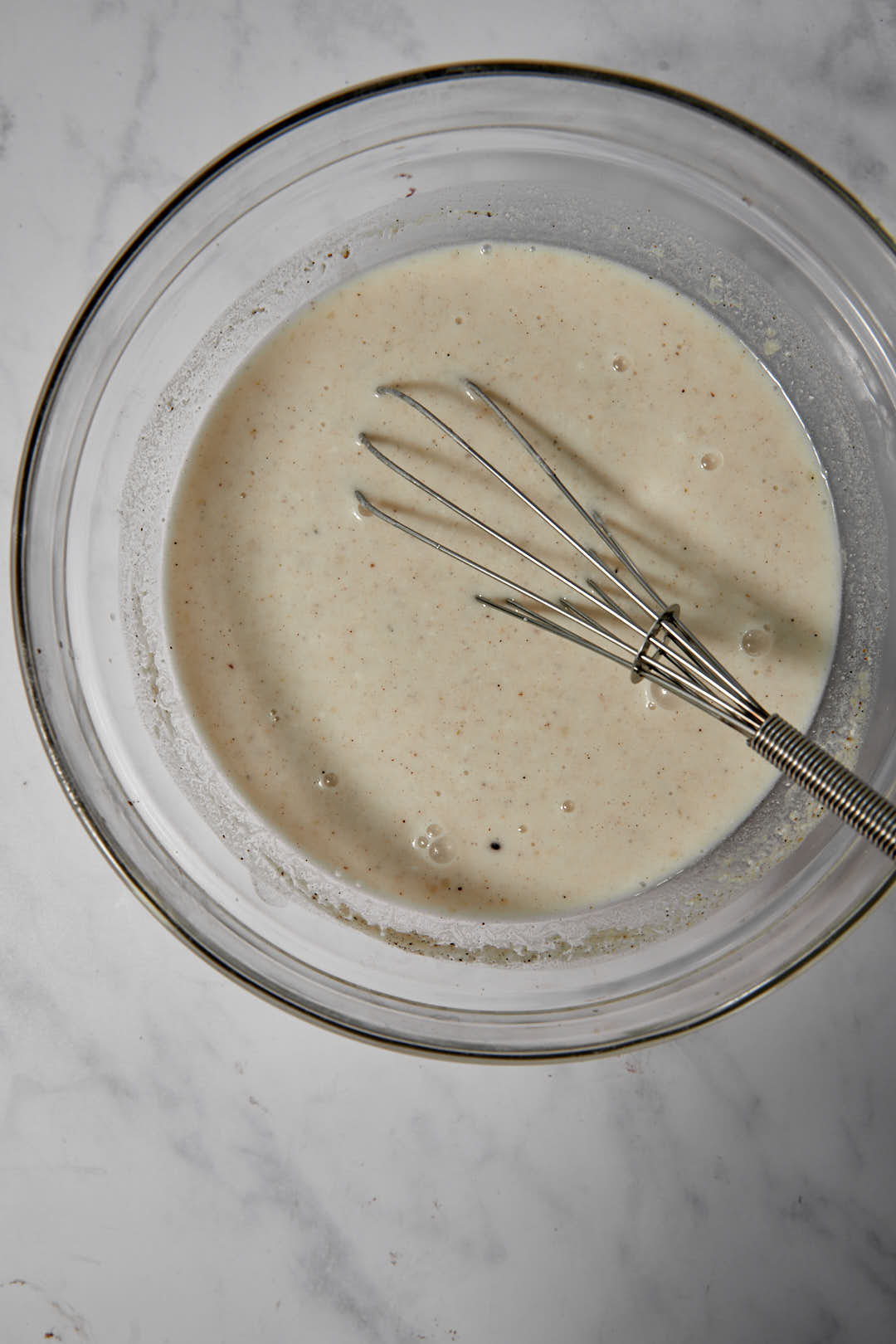 tahini yogurt sauce whisked together in a bowl.