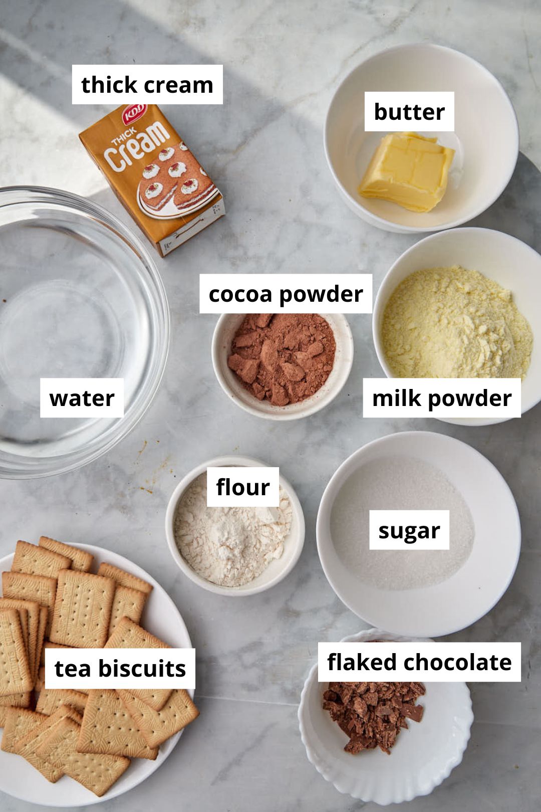 ingredients needed to make chocolate biscuit pudding on a white background.