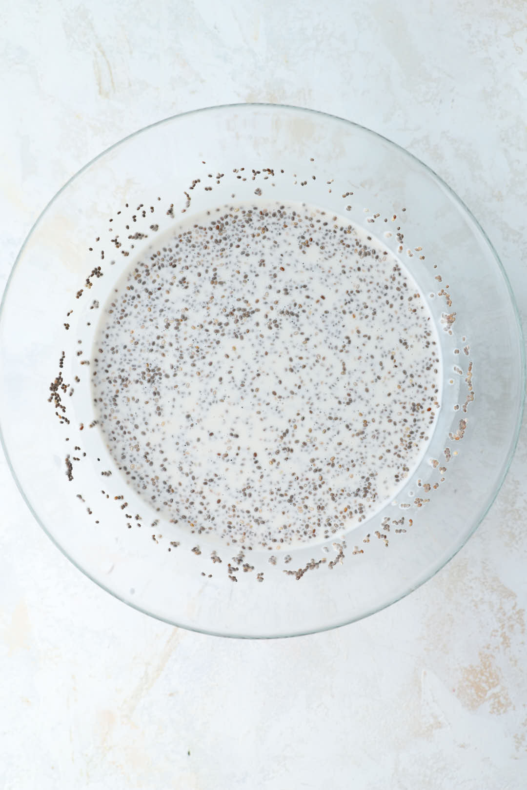 coconut milk and chia seeds in a glass bowl.