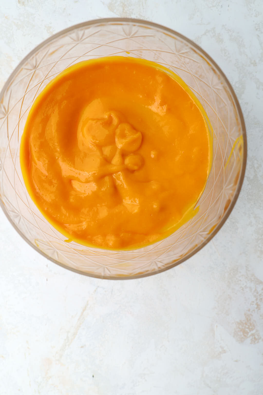 mango puree on the base of a serving dish.